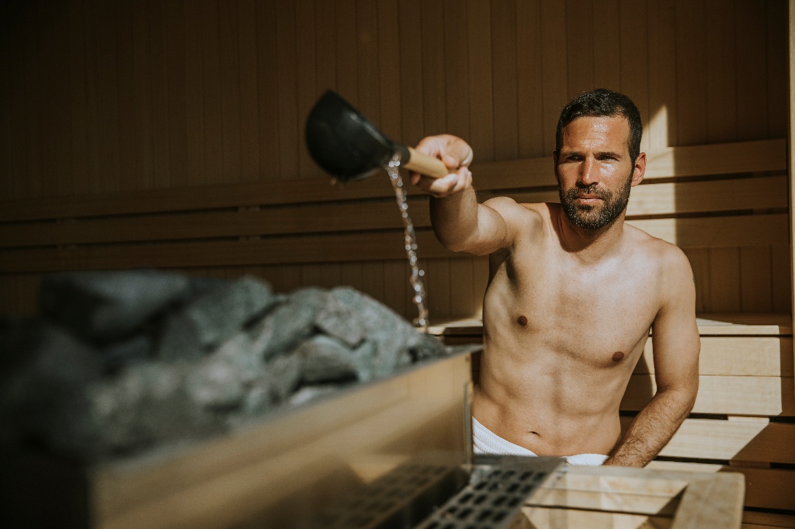 Pouring water onto sauna stones
