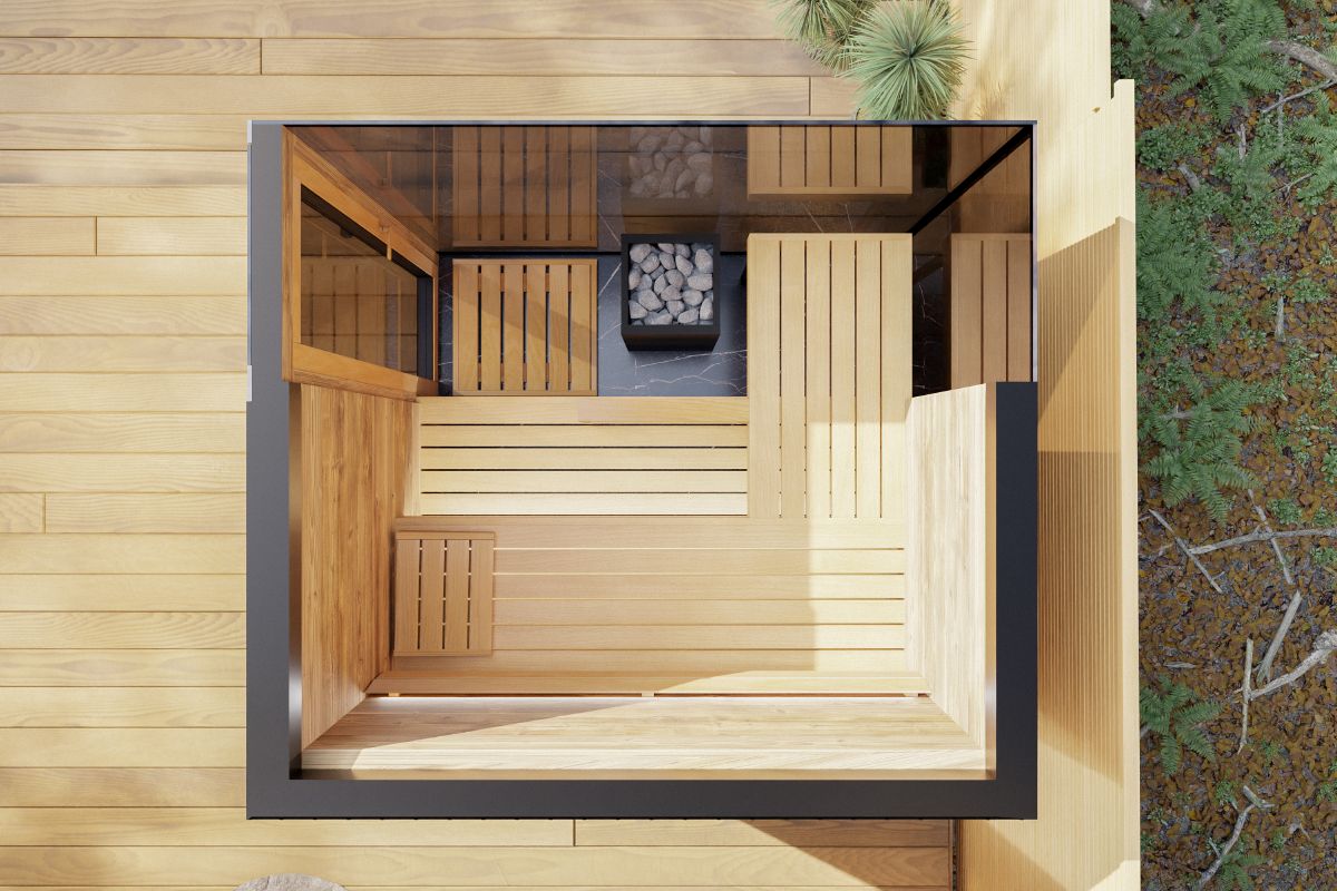 The interior of the sauna can be seen from above – wooden benches are arranged along the walls, and a stove with stones is installed in the center.